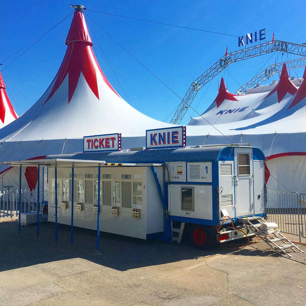 Ticketwagen vor dem Circus-Zelt mit Knie-Signaletik